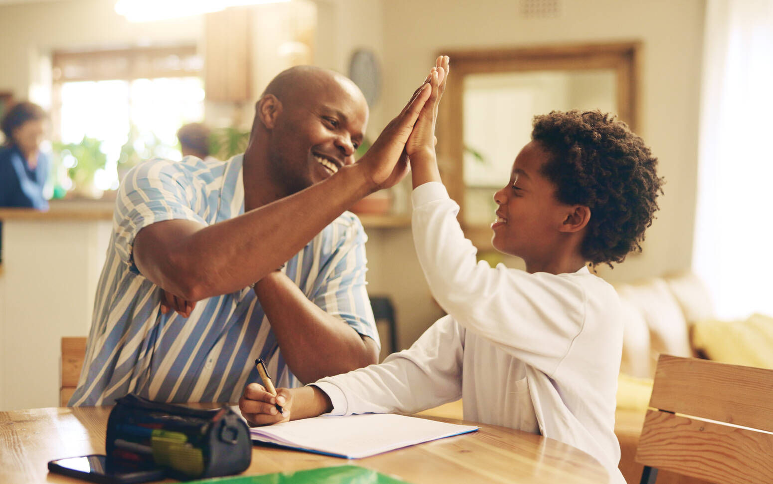 Child-and-parent-high-fiving