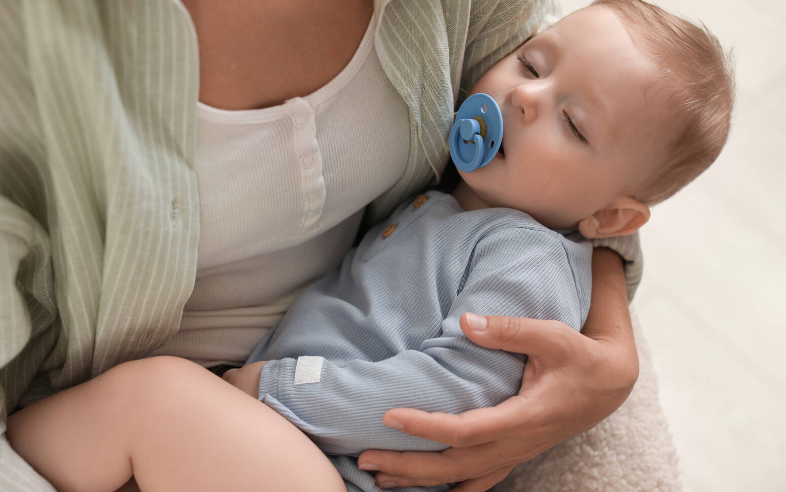 parent-holding-sleeping-baby
