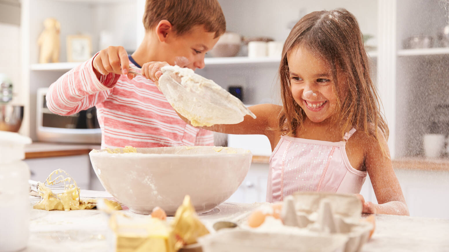 boy and girl baking in kitchen