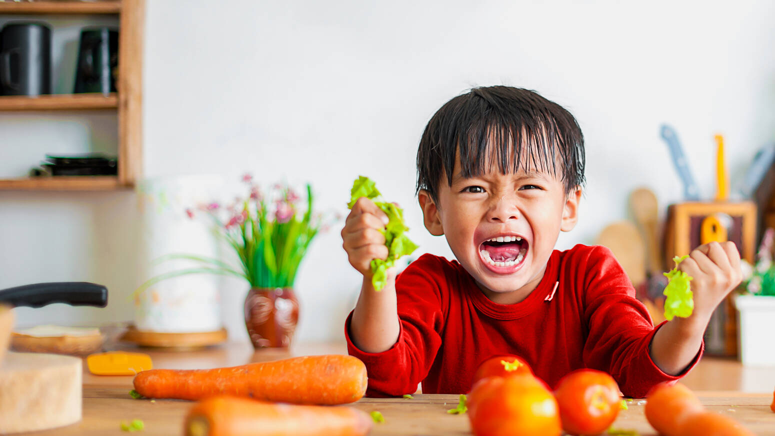 child-holding-vegetables-crying