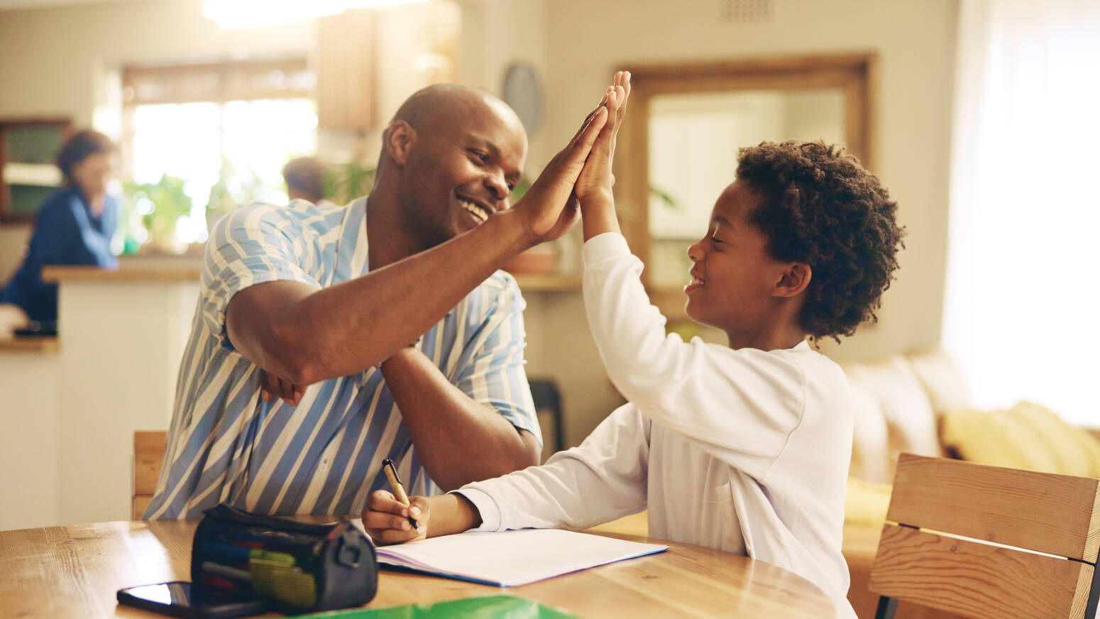 Child-and-parent-high-fiving