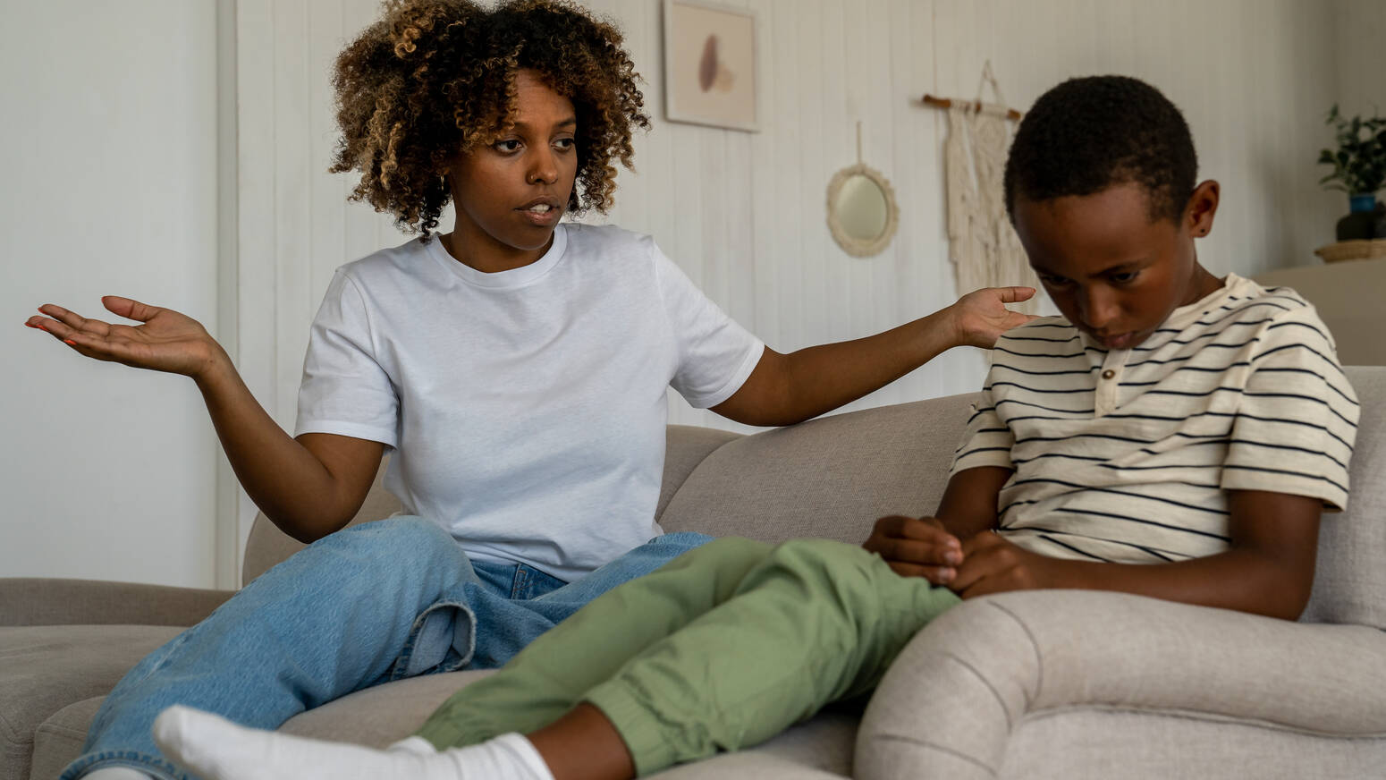 Mother talking to child looking confused child sitting upset
