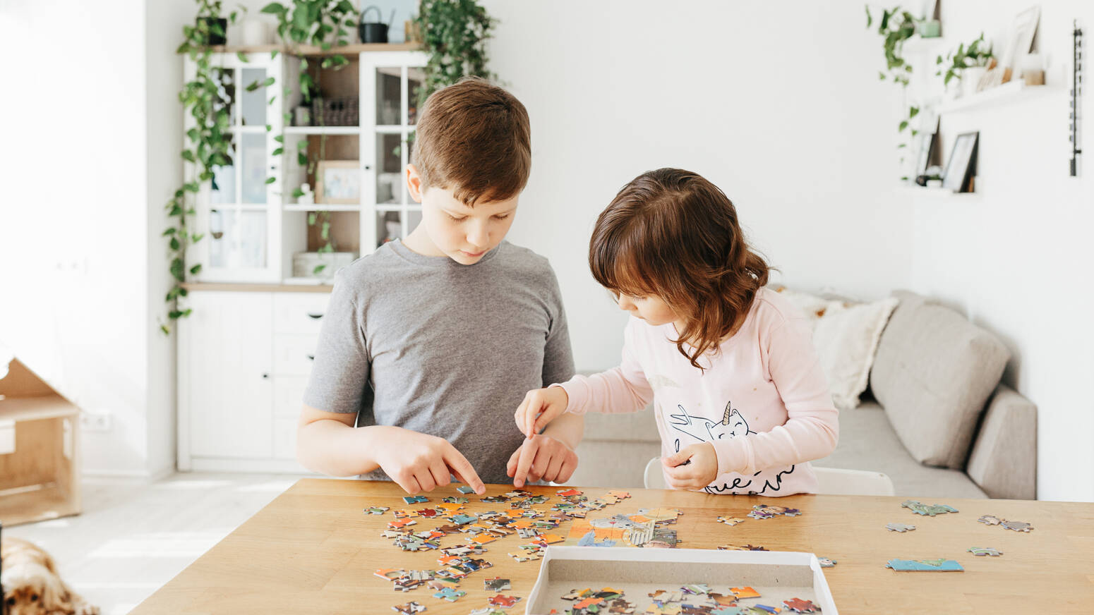 Two kids making a puzzle together