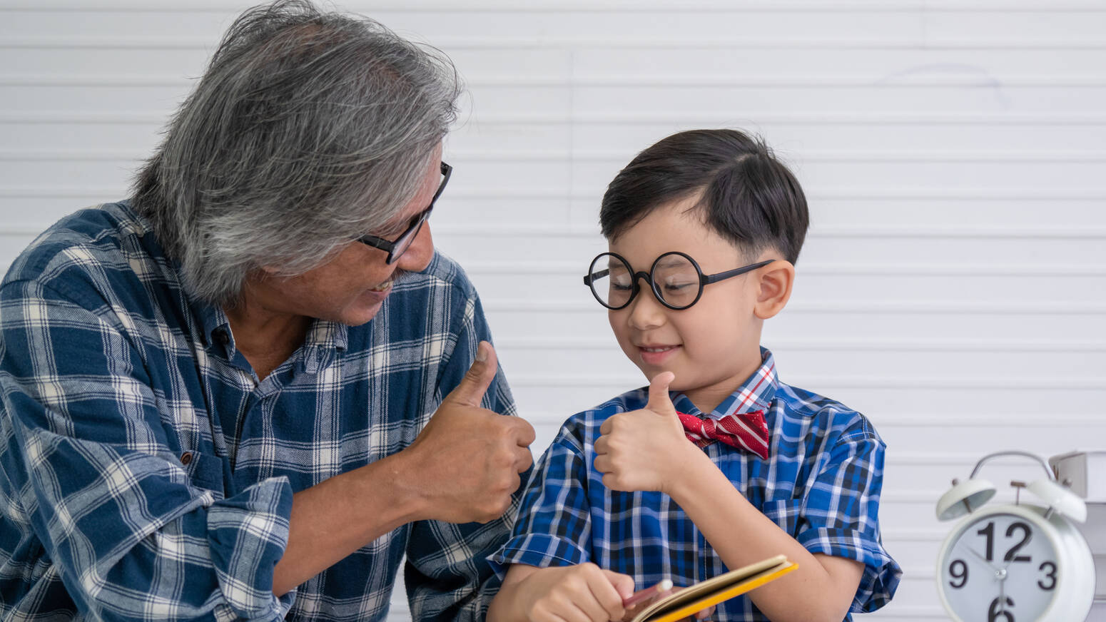 Kid and adult giving thumbs up