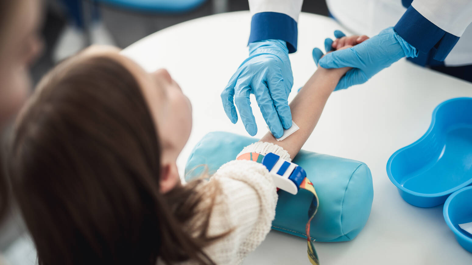young girl at doctor getting blood drawn