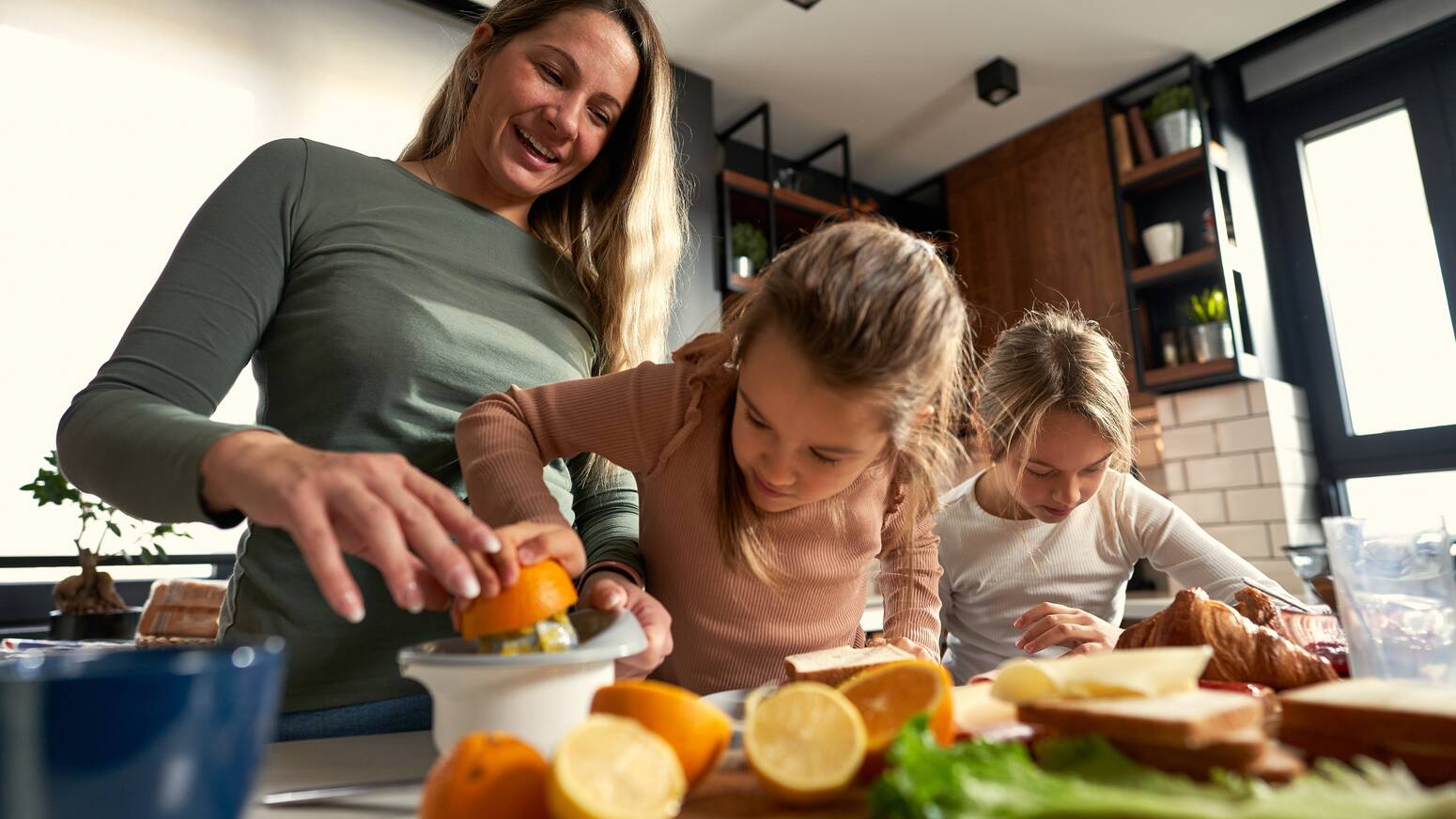 boy and girl cooking with mom in kitchen