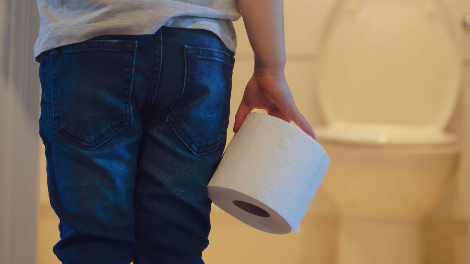 child-holding-toilet-paper