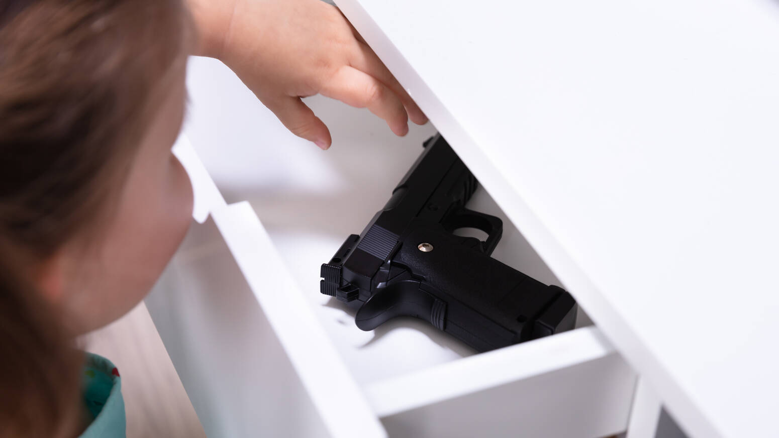 child-looking-at-firearm