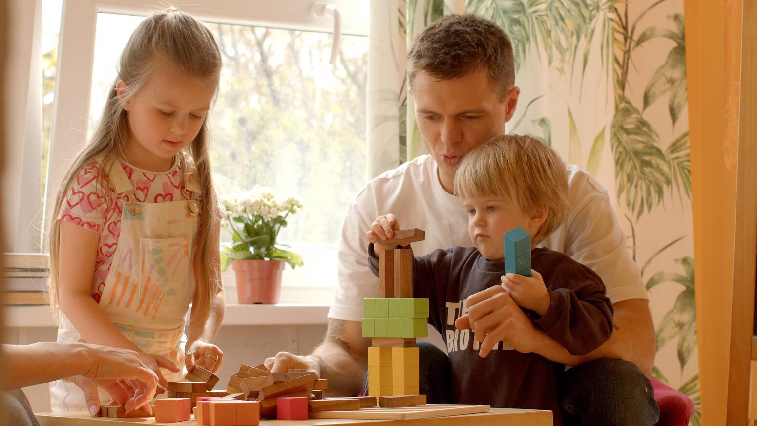 Family of three playing with blocks