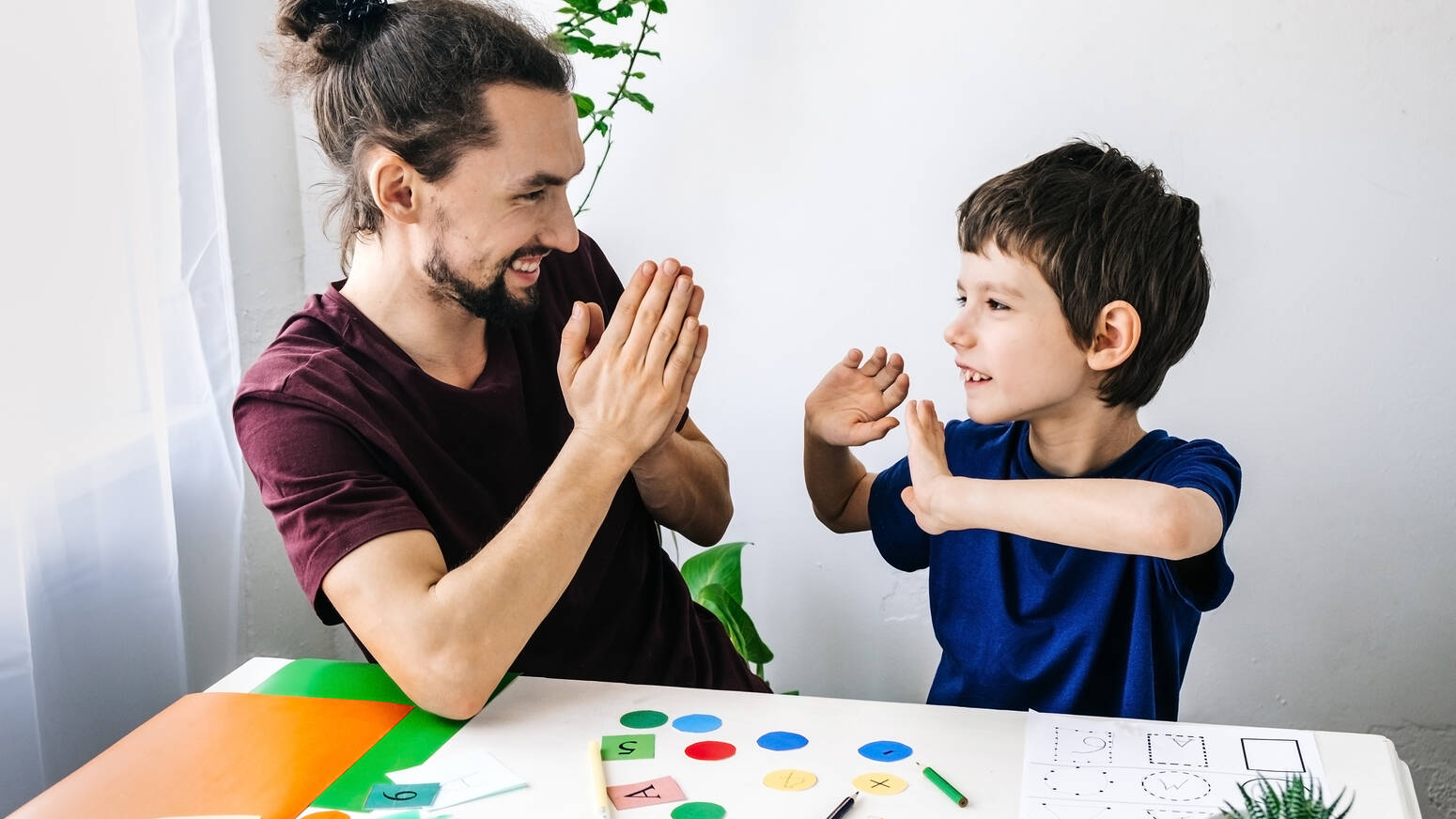 Child and adult clapping