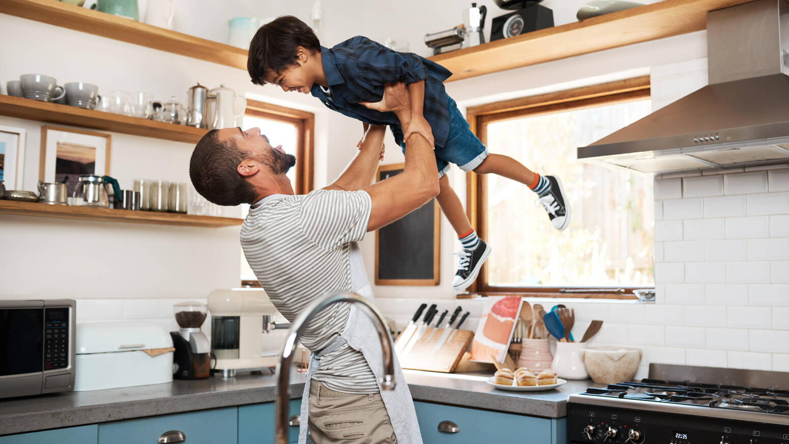 Parent playfully holding child
