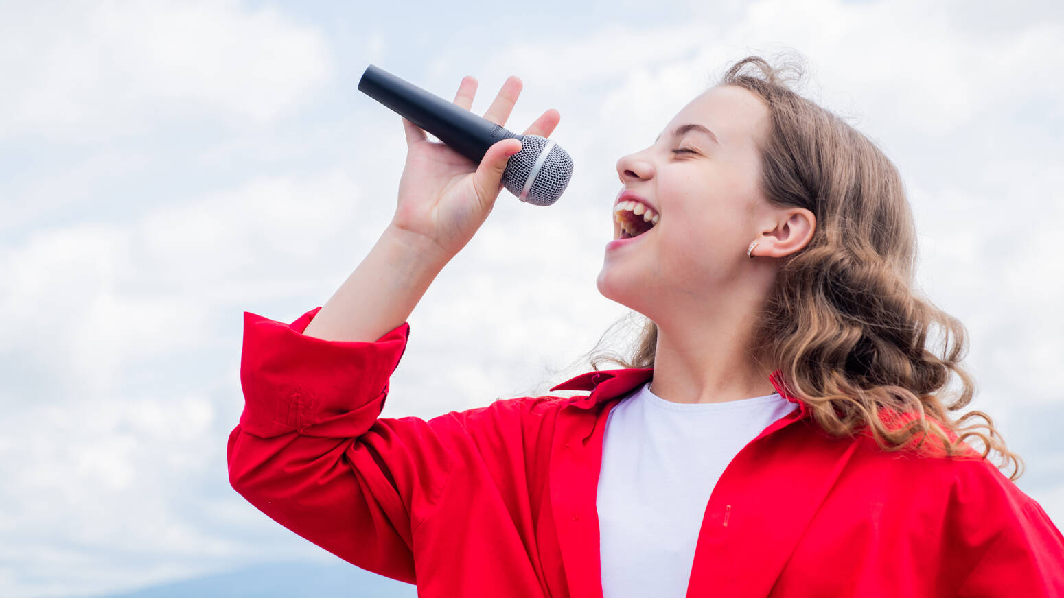 Person singing with mic in hand