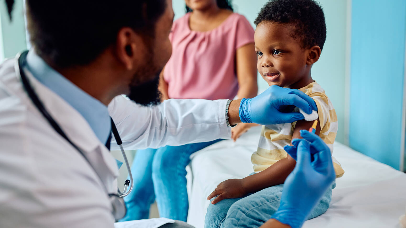 doctor giving boy vaccine