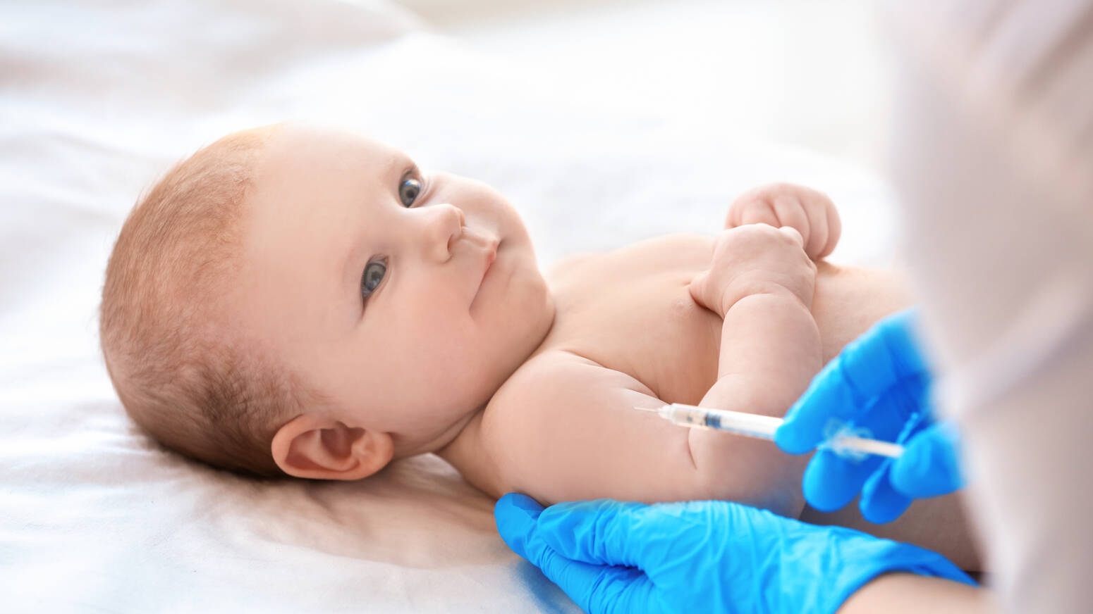 baby smiling getting vaccine