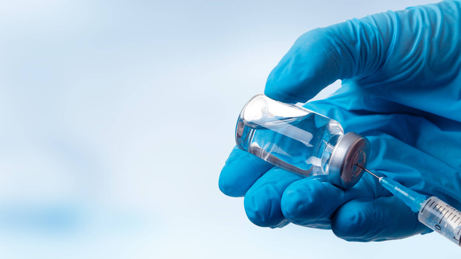hand with glove on using vaccine
