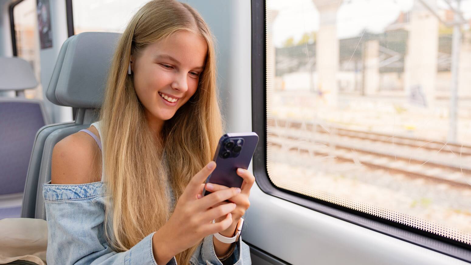 teen on train on phone