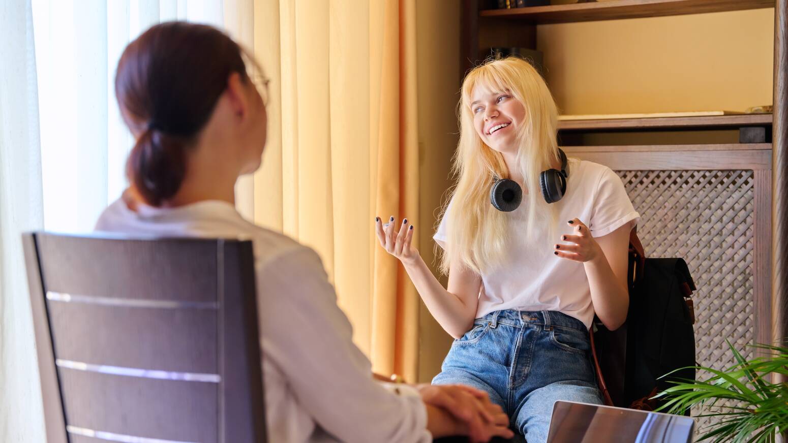 teen sitting talking to someone understanding