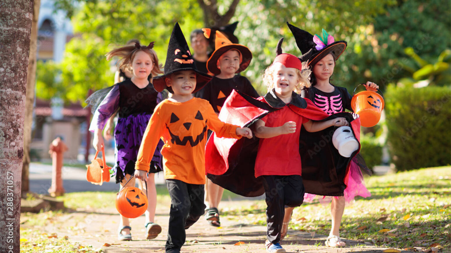 children on sidewalk in halloween costumes