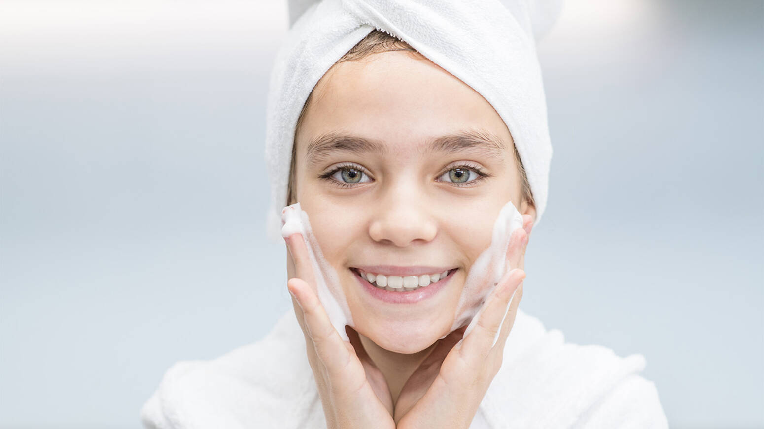 Young girl washing her face