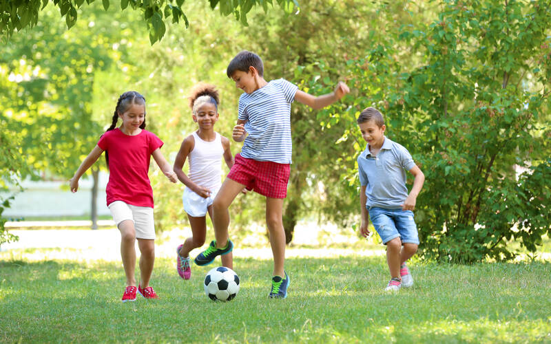 Young kids playing soccer