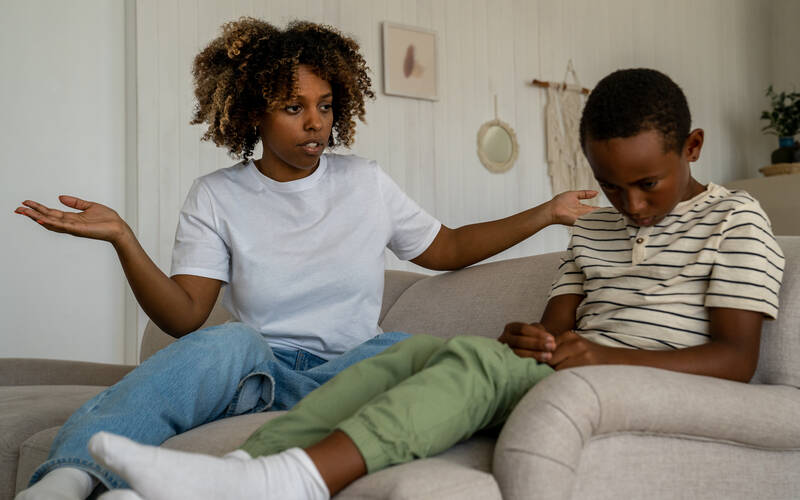Mother talking to child looking confused child sitting upset