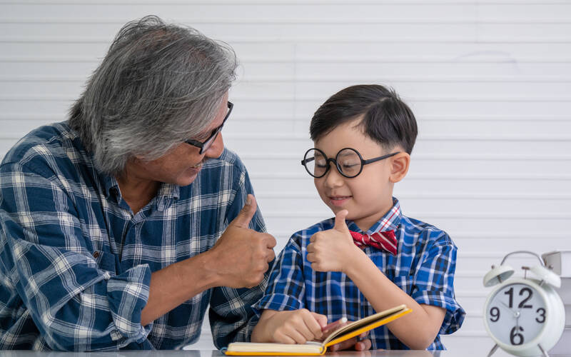 Kid and adult giving thumbs up 