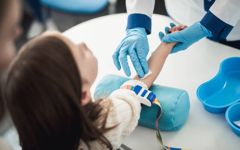 young girl at doctor getting blood drawn
