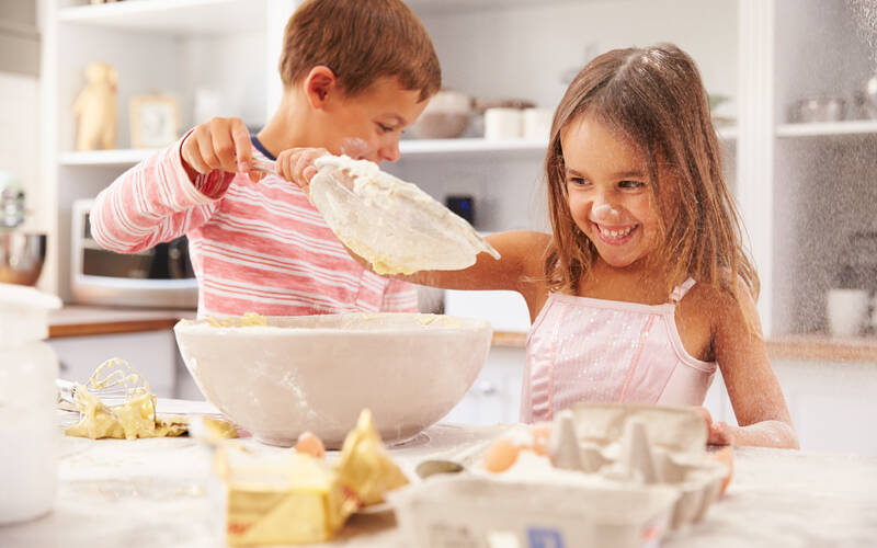 boy and girl cooking in kitchen