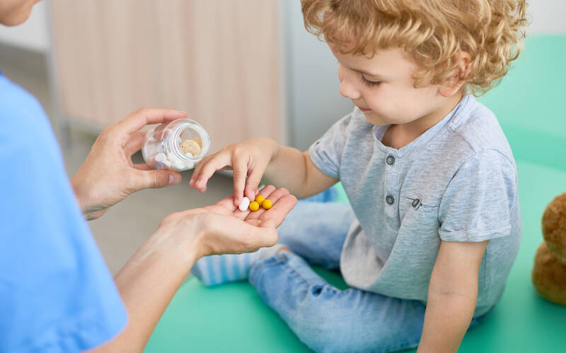 child-holding-medicine 