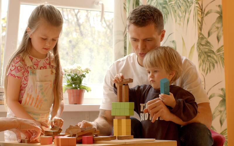 Family of three playing with blocks