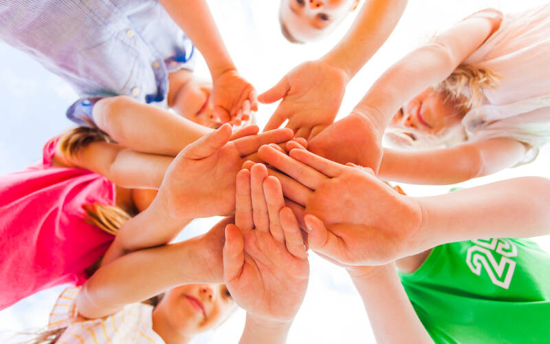 Group of kids in a hand stack
