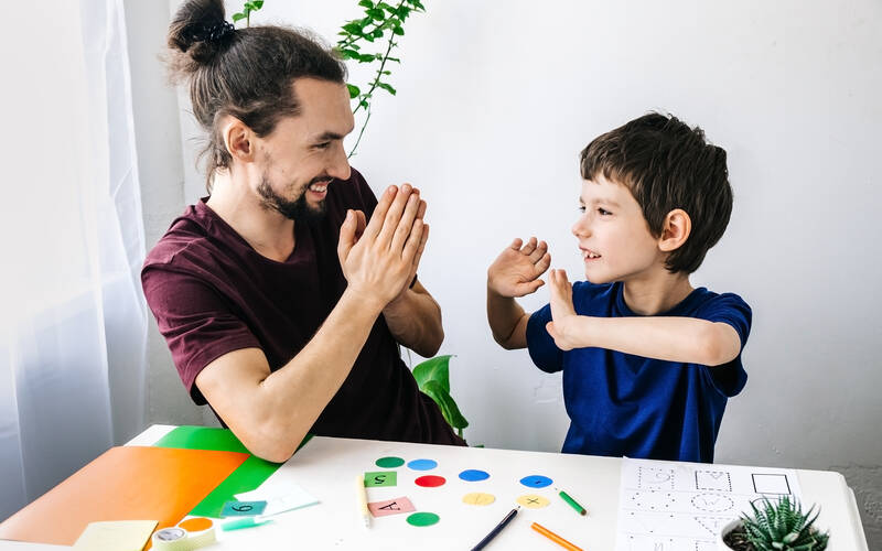 Child and adult clapping
