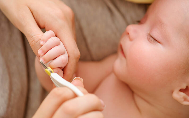 Newborn getting nails clipped