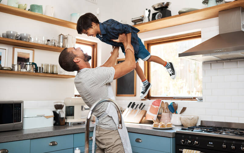 Parent playfully holding child