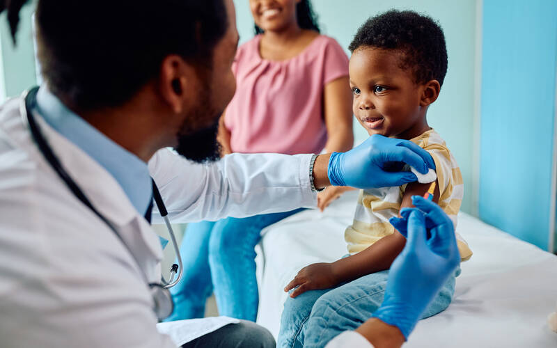 doctor giving boy vaccine