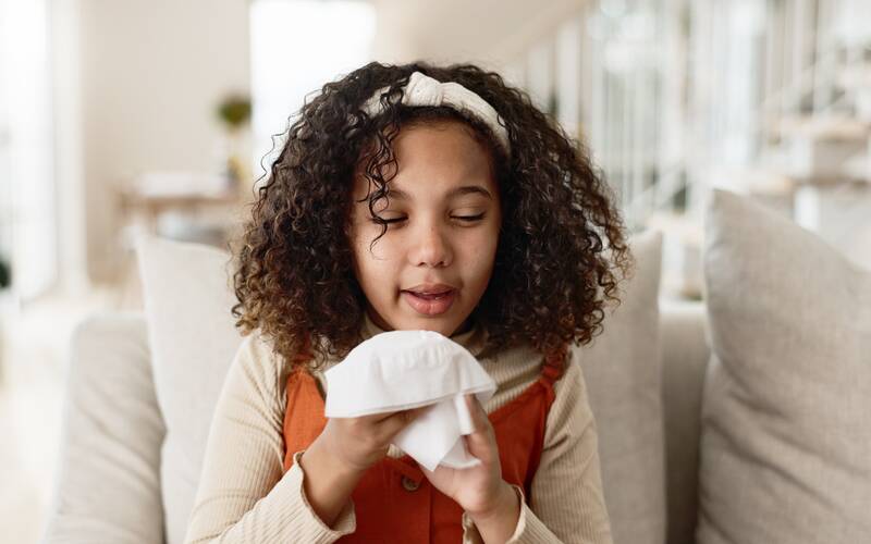 Young girl holding tissue
