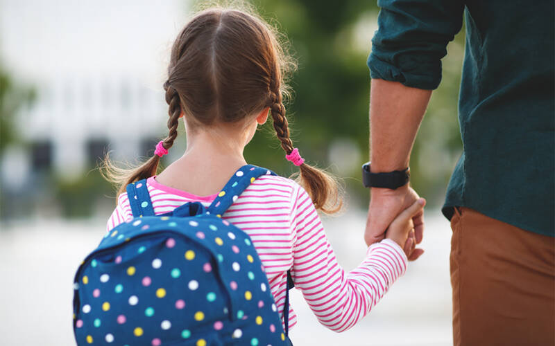 Girl going to school with a backpack