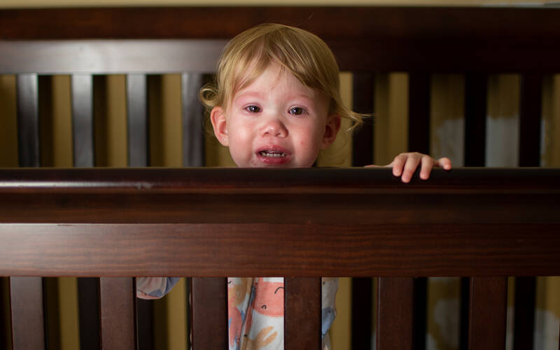 child-standing-in-crib