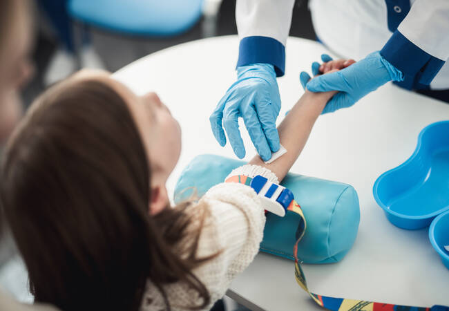 young girl at doctor getting blood drawn