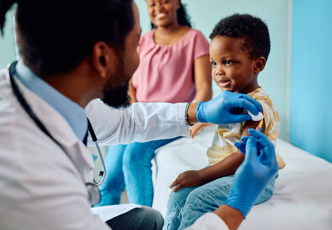 doctor giving boy vaccine