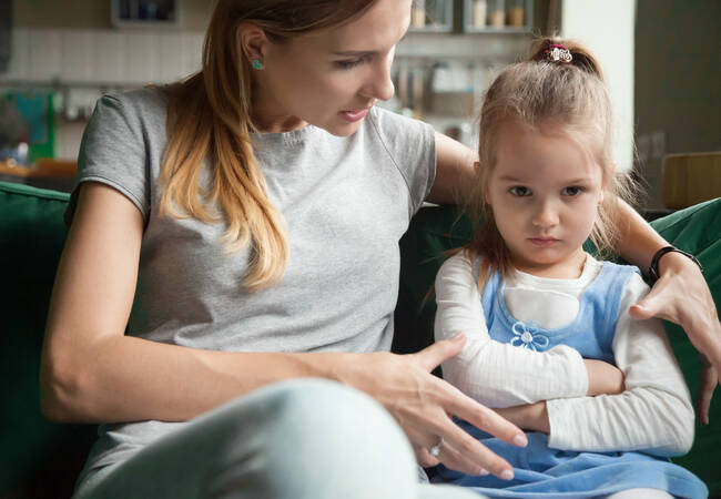 mom comforting pouting daughter
