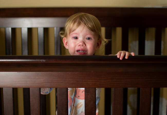 child-standing-in-crib