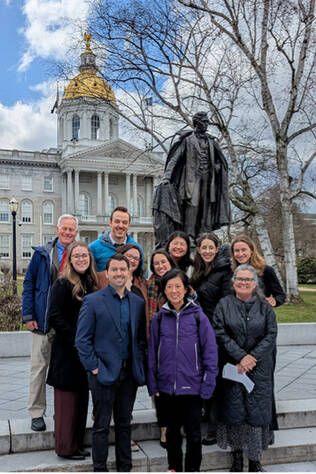 Pediatric residents pose on the steps in front of the NH State House