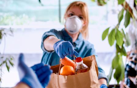 Women handing over bag of food