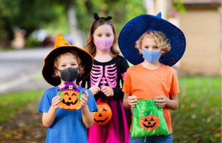 Kids in masks trick-or-treating 