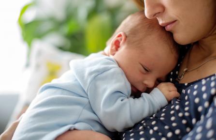 Infant lying on mother's chest