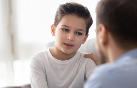 young boy and dad talking