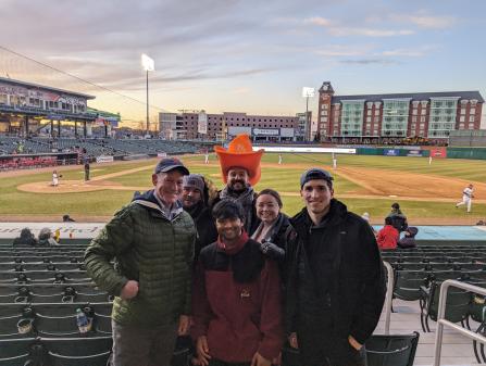 Residents and faculty attending baseball game