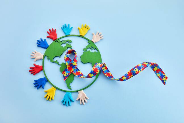 Autism awareness colors with hands and the globe