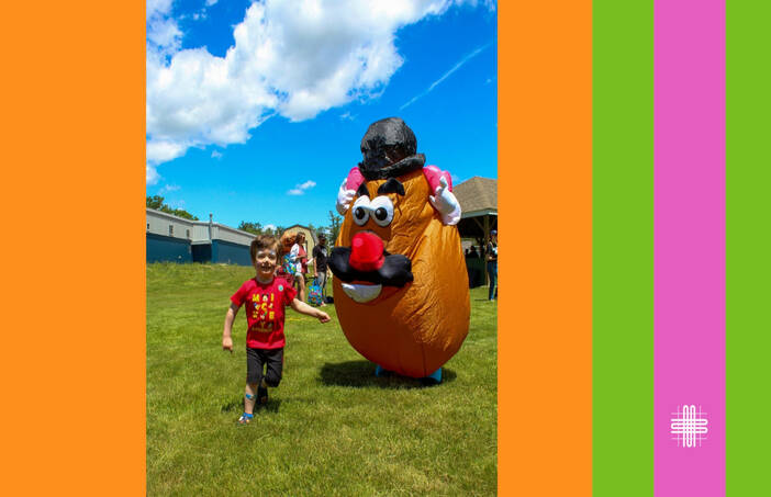 Child playing outside next to adult in Mr. Potato Head costume